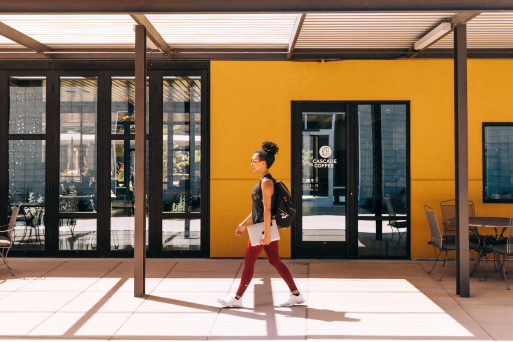 Showit Health and Wellness Website - Showit Health and Wellness Guru walking with computer to set up her Showit Website.