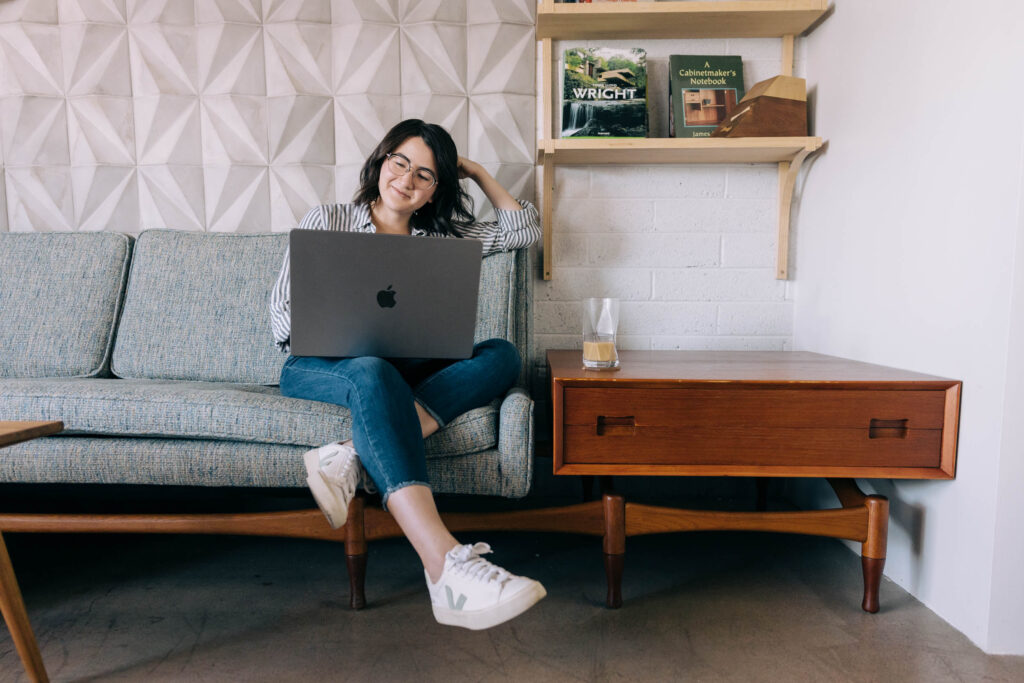 Image of a woman making a personal website on a laptop.