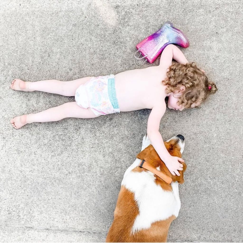Take Photos of Your Kid - Showit little girl lying down with her dog
