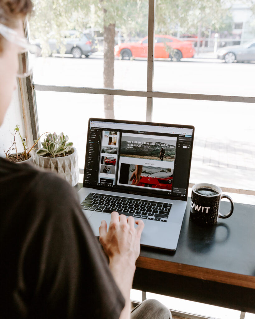 Showit vs. Behance: Someone creating a portfolio on a computer.