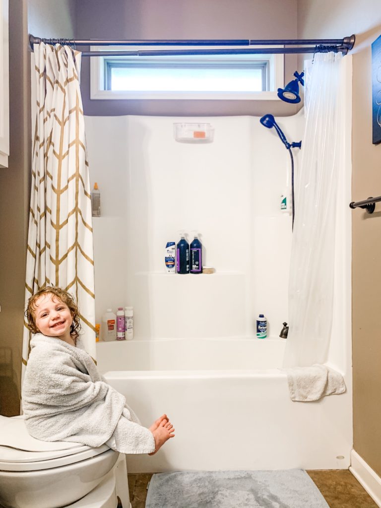 Photo by a mom of her kid after a shower - Showit little girl in towel after her bath wrapped in a towel