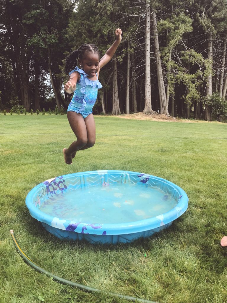 kiana-bosman-EY7z4AVLs9Y-unsplash - Showit kid jumping into plastic pool